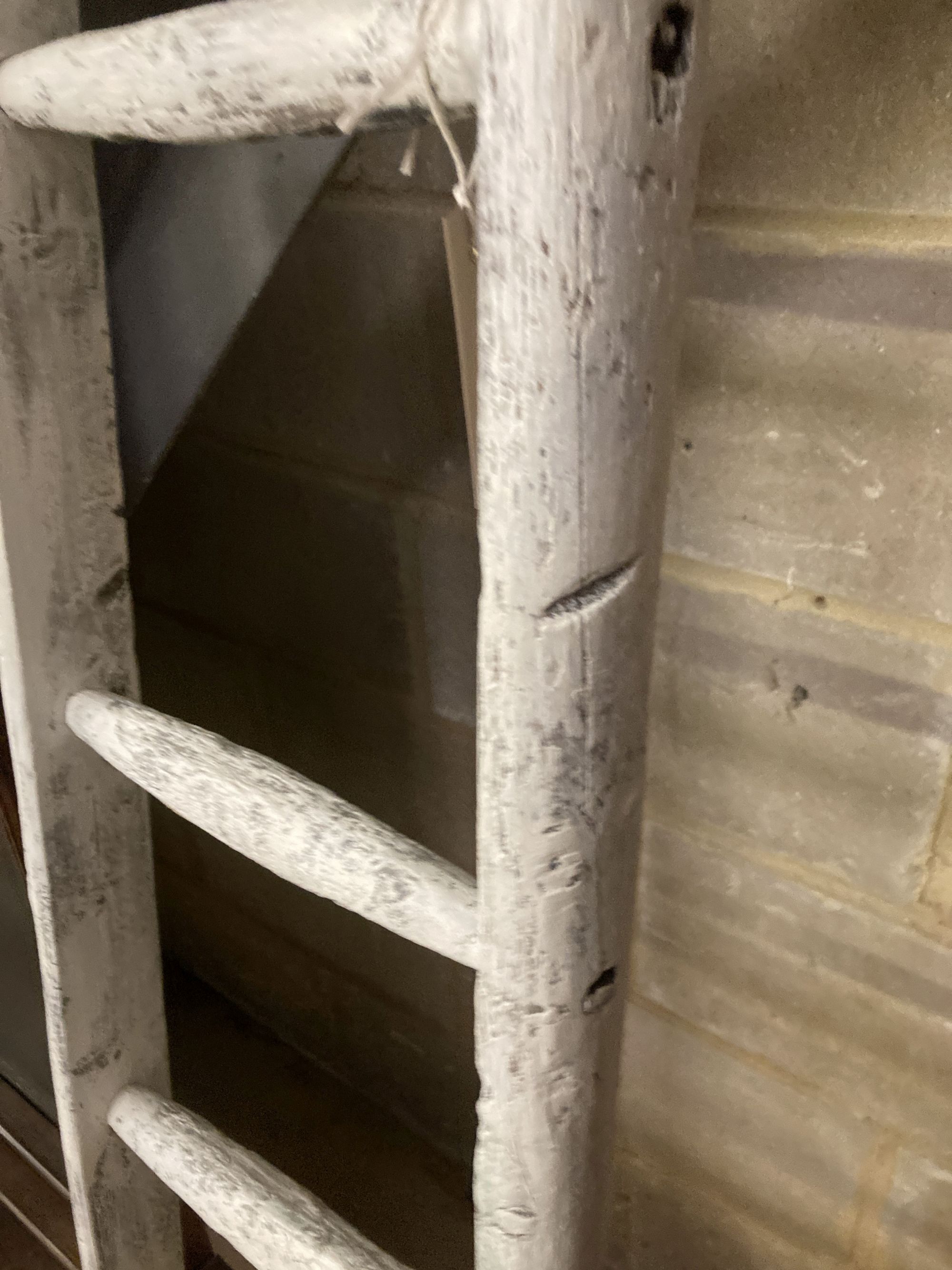 A vintage white painted wood seven tread ladder, width 30cm, height 170cm